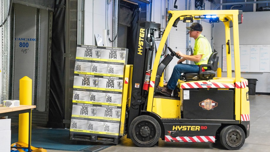 Man Riding A Yellow Forklift With Boxes 1267324